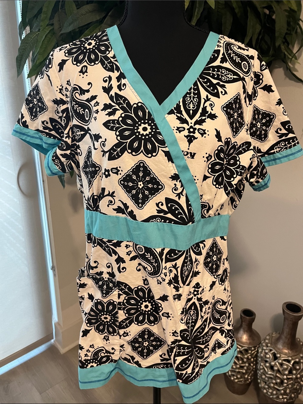 Koi Black & White Floral Wrap Scrub Top with Teal Trim